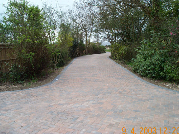 A large driveway built to replace an old and muddy gravel drive. The fence to the left has also been replaced with an oak closeboard fence.
