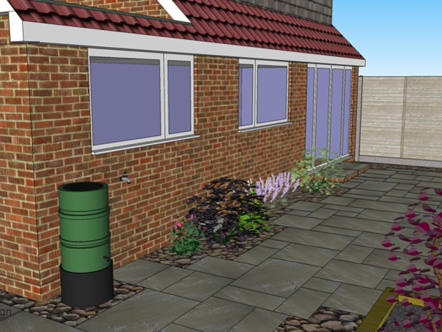 A 3D garden design showing a random rectangular patio surrounded by cobbles and planting to create a soft look to the area.