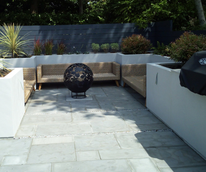 A garden design and landscape project with seating, lighting, paving, raised beds, barbeque, fire pit, planting, screening