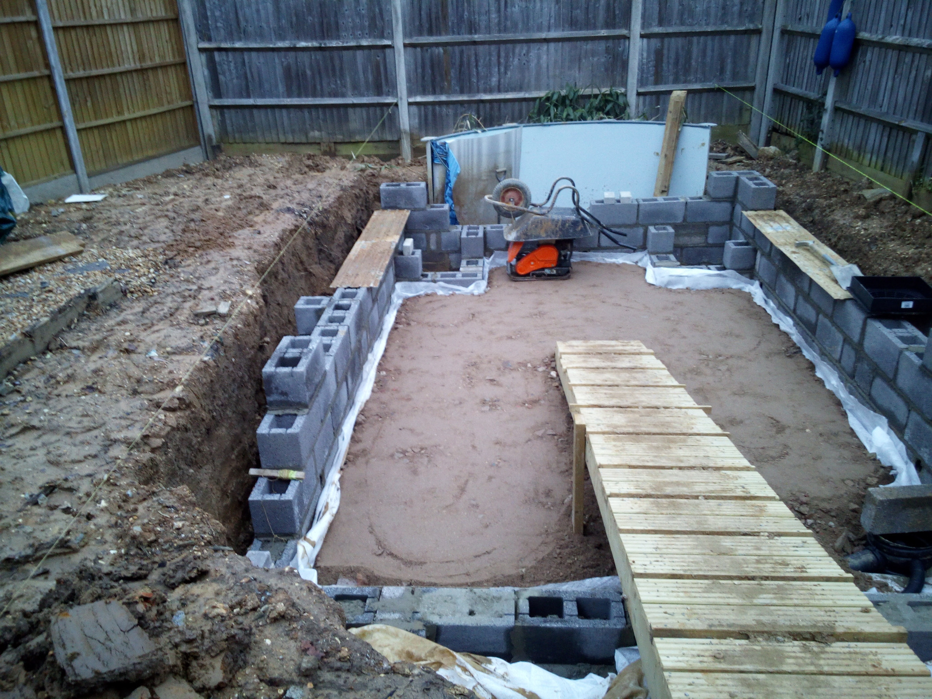 Complete garden makeover in Whiteley with paving, retaining walls, Sunken garden, artificial grass, fencing and planting