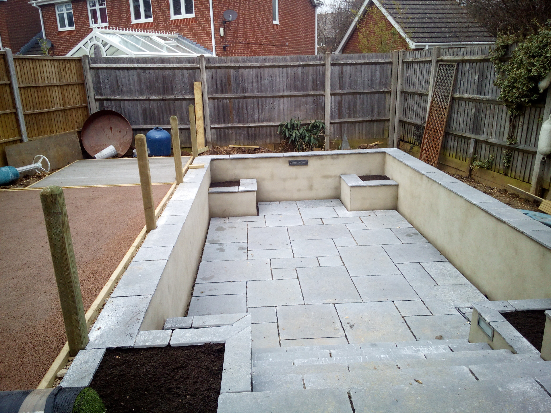 Complete garden makeover in Whiteley with paving, retaining walls, Sunken garden, artificial grass, fencing and planting