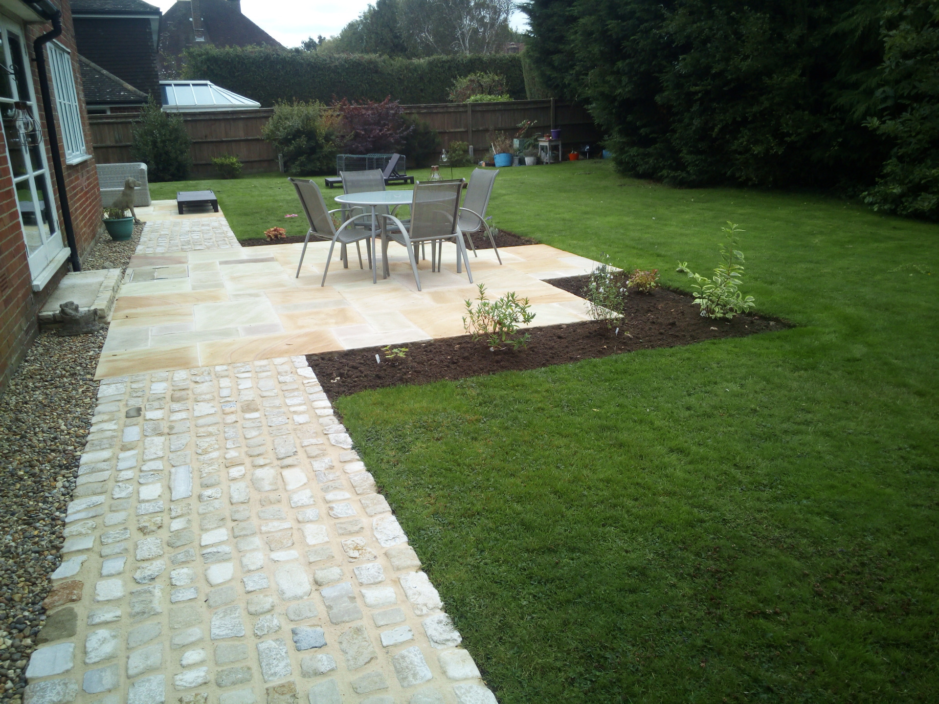 Examples of Wyld Landscapes work with paving, hedging, planting, paths, shed, cobbles, lawn, fencing, pergola, design