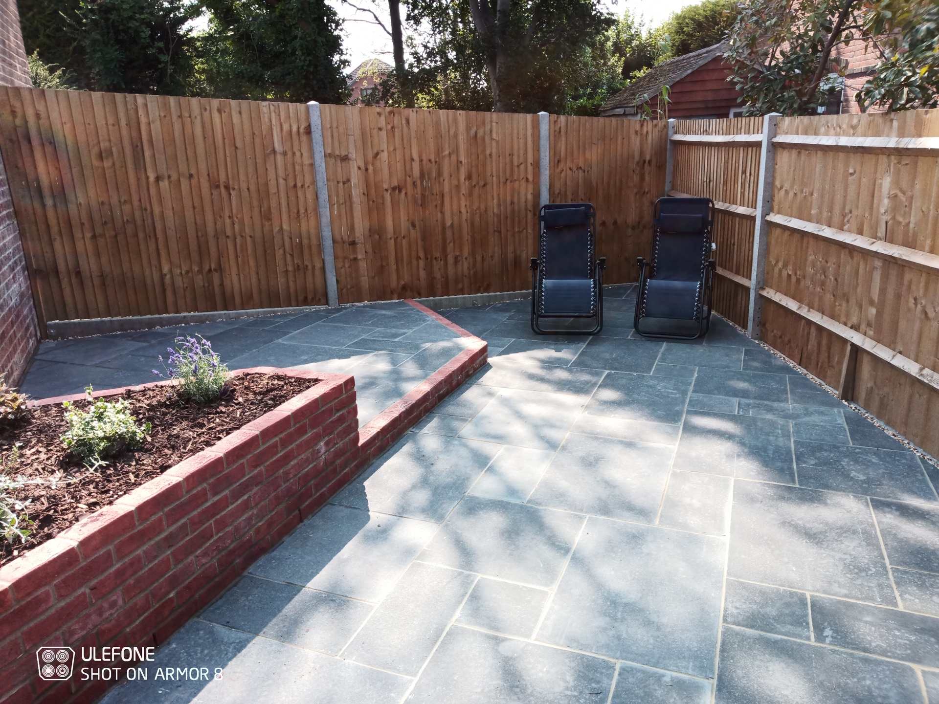A garden makeover with new limestone paving, fencing. bricks walls, raised planters, steps, planting and hot tub area