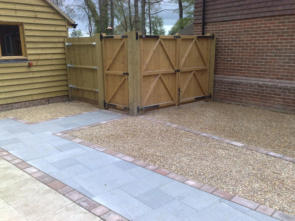 A new fence with double gates to allow for boat storage and a pedestrian gate for general use. Granite paving provides smooth paths through the gravel storage areas.